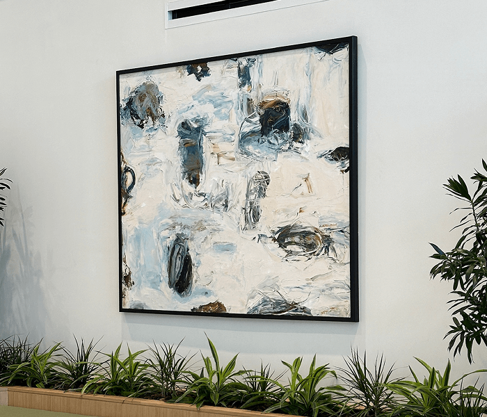 A painting displayed on the wall of a room, showcasing vibrant colors and abstract shapes.