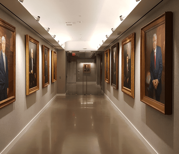 A hallway featuring framed pictures on the walls