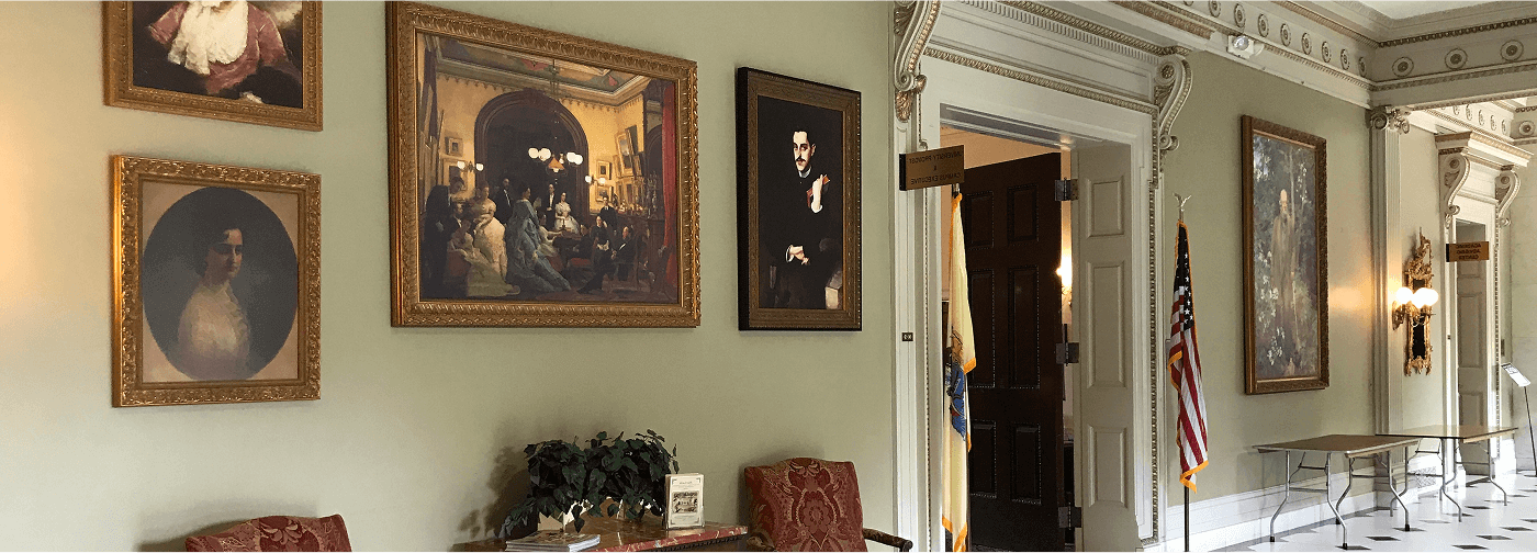 A hallway adorned with various paintings and pictures displayed on the walls, creating an artistic atmosphere.