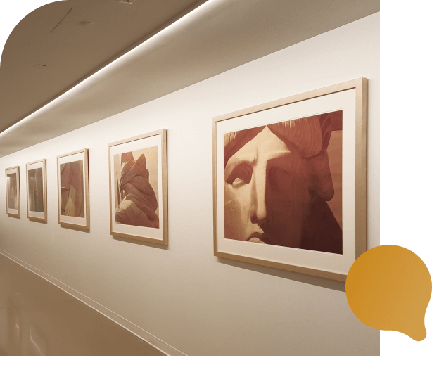 A long hallway featuring several framed pictures displayed on the walls, creating an inviting atmosphere.