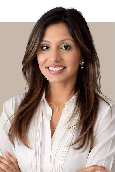 A woman in a white shirt and gold necklace, exuding elegance and warmth in her expression.