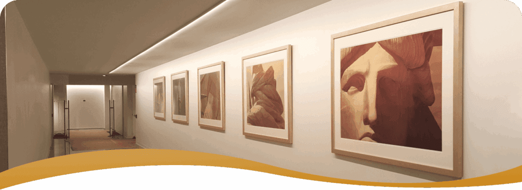 Art gallery with framed portraits displayed.