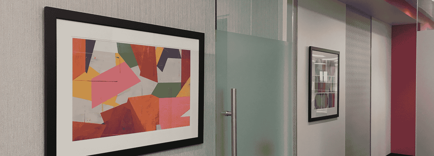 A hallway adorned with vibrant artwork on the walls, creating a lively and colorful atmosphere.