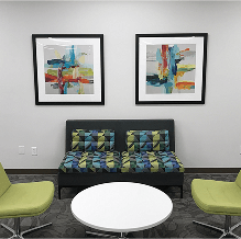 Modern seating with colorful artwork.