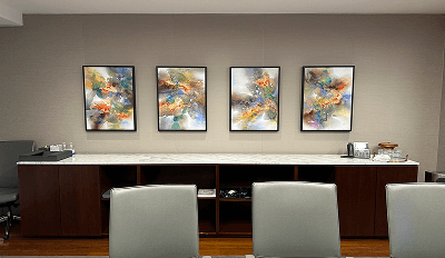A conference room featuring three paintings displayed on the wall, enhancing the professional atmosphere.