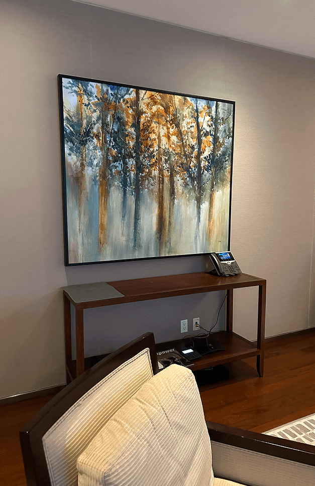 A room featuring several chairs arranged around a central table, creating a cozy seating area.